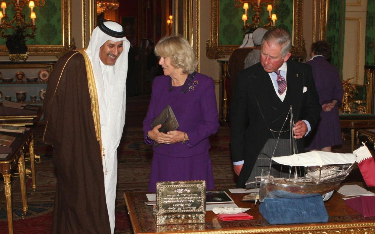 Prince Charles and Camilla, Duchess of Cornwall, show Sheikh Hamad bin Jassim around exhibits from the Royal Collection at Windsor Castle during his state visit on October 26, 2010 - WPA/Getty