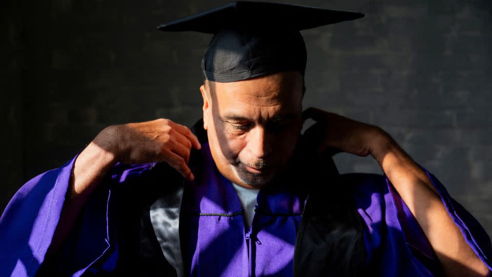 James Soto adjusts his regalia during a November graduation ceremony for students of the Northwestern Prison Education Program at Stateville Correctional Center in Crest Hill, Illinois. - Vincent Alban/Reuters