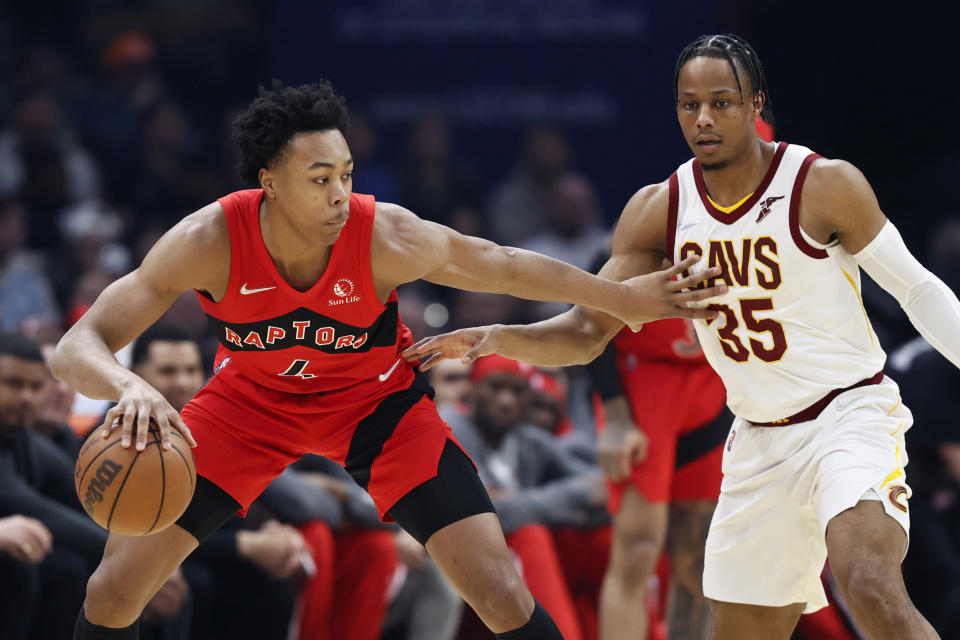 Toronto Raptors' Scottie Barnes (4) works against Cleveland Cavaliers' Isaac Okoro (35) during the first half of an NBA basketball game, Sunday, March 6, 2022, in Cleveland. (AP Photo/Ron Schwane)