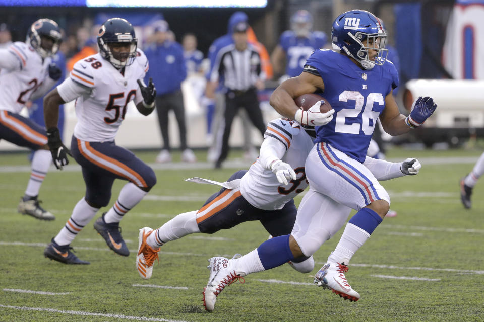 New York Giants running back Saquon Barkley (26) runs with the ball as Chicago Bears free safety Eddie Jackson (39) moves in to make the tackle during the second half of an NFL football game, Sunday, Dec. 2, 2018, in East Rutherford, N.J. (AP Photo/Seth Wenig)