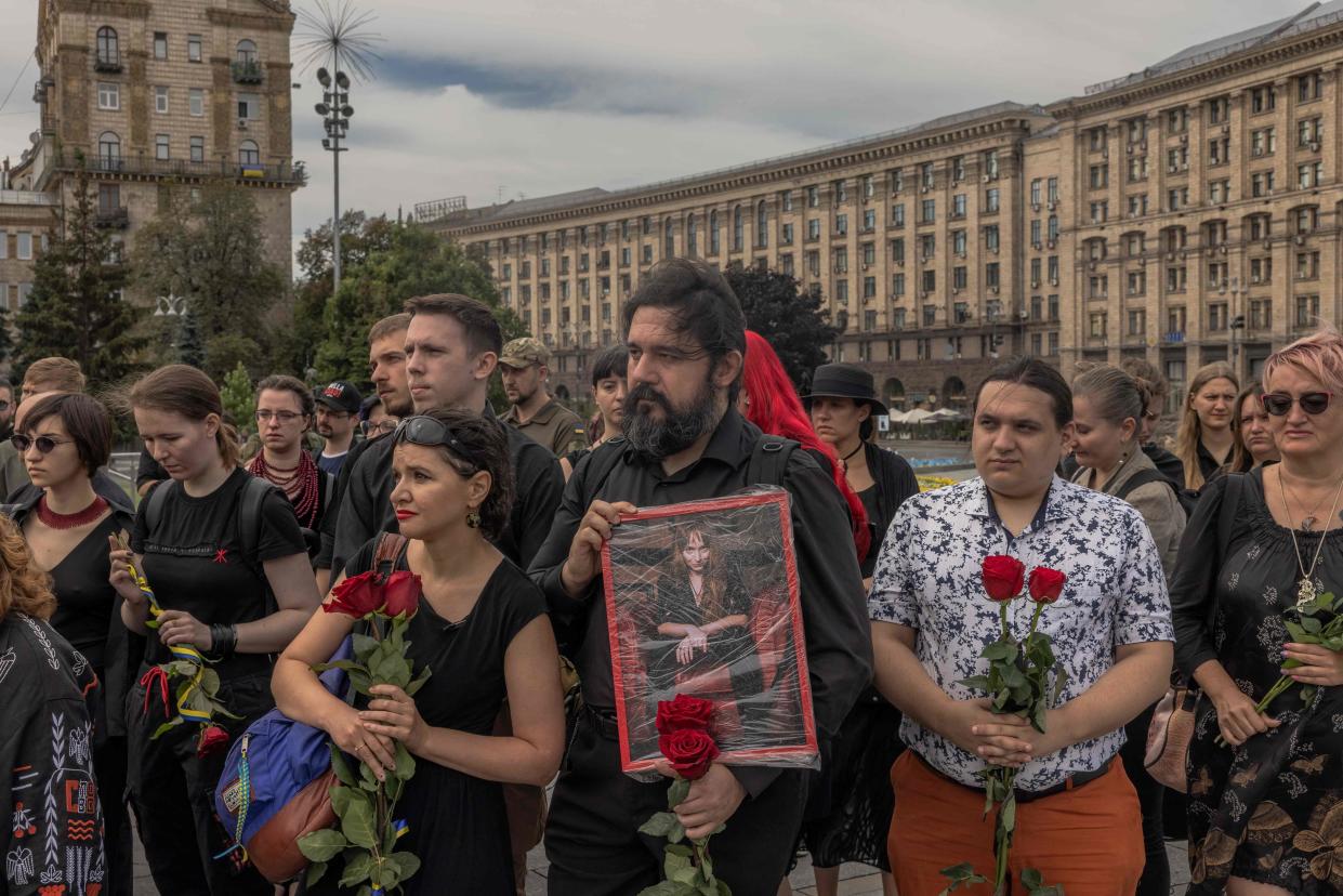People hold flowers and a portrait of Daria Filipieva, a Ukrainian army combat medic who was killed in the Donetsk region (AFP via Getty Images)