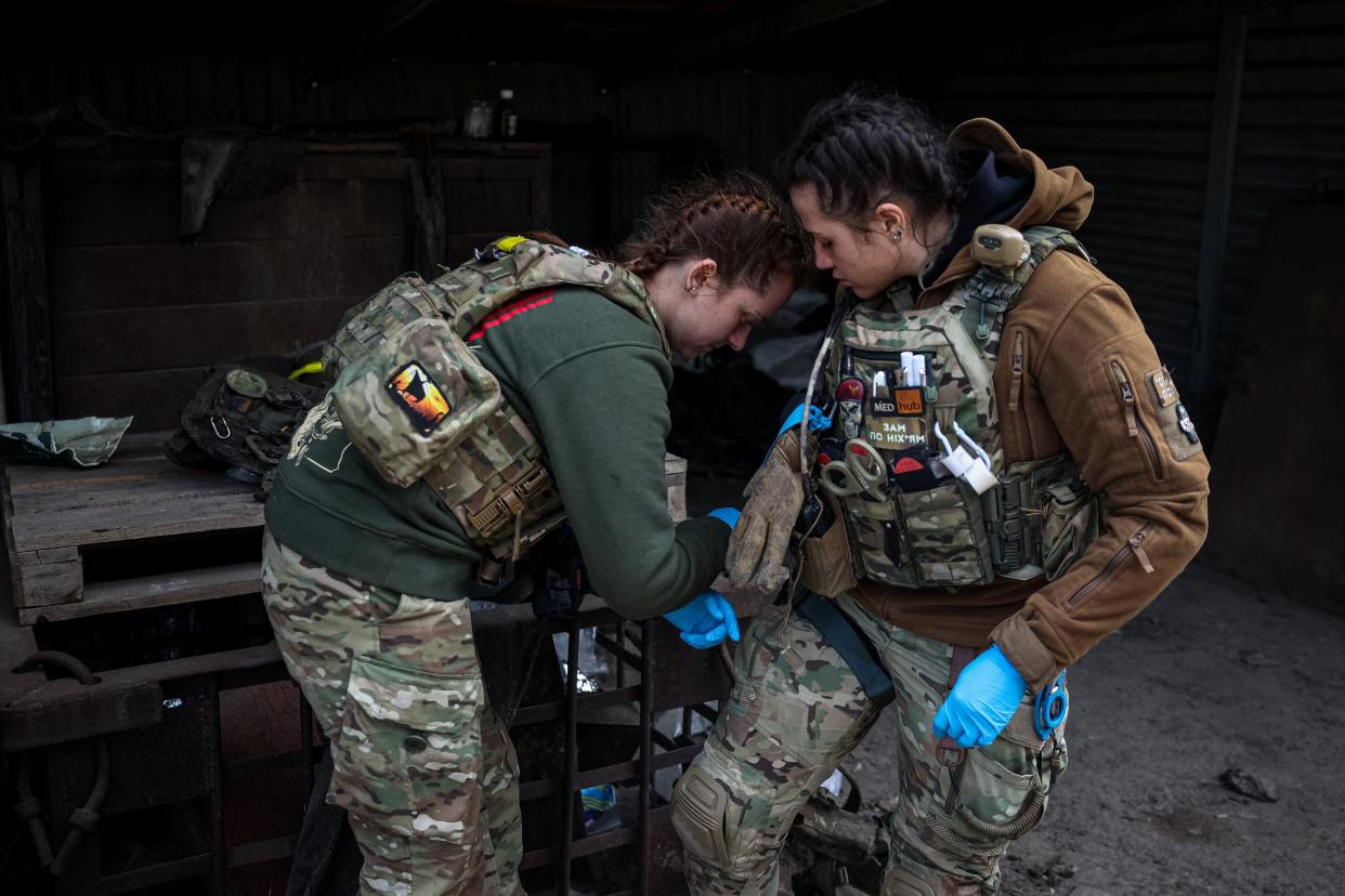 Medics prepare to treat a wounded Ukrainian serviceman at a frontline medical stabilisation point near Bakhmut, Donetsk region (AFP via Getty Images)