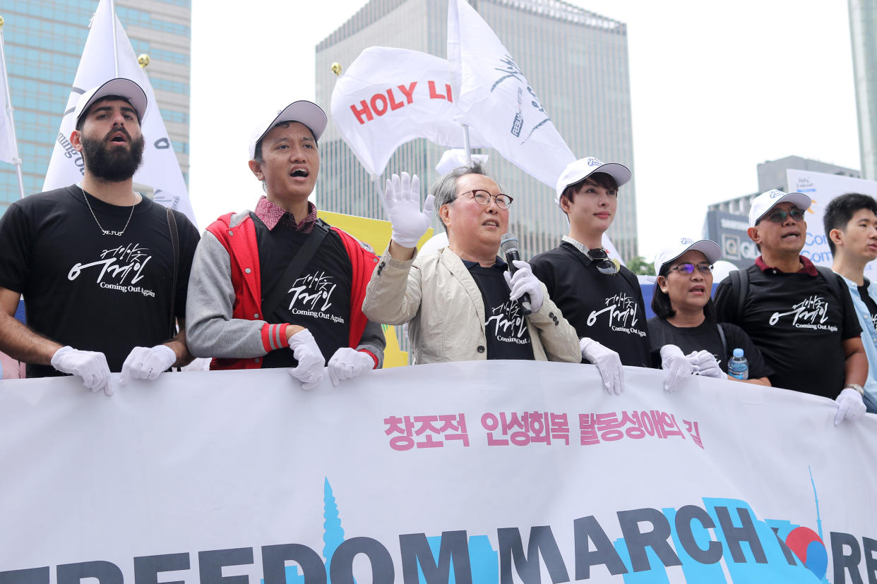 Pastor Yonah Lee, center, leads an 