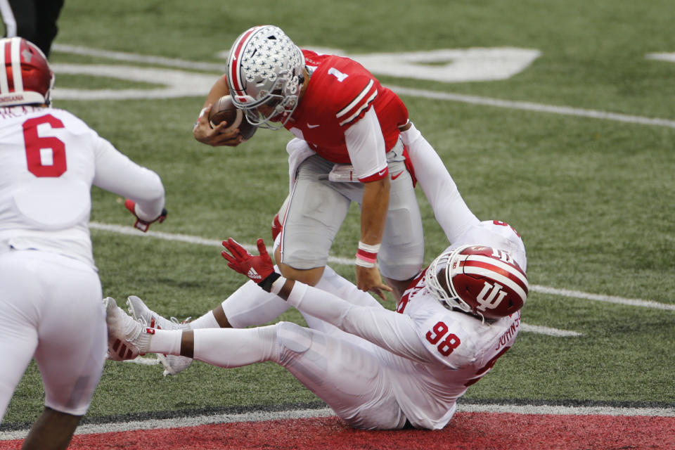 Indiana defensive lineman Jerome Johnson, bottom, sacks Ohio State quarterback Justin Fields during the first half of an NCAA college football game Saturday, Nov. 21, 2020, in Columbus, Ohio. (AP Photo/Jay LaPrete)