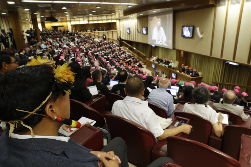 Participants attend the Amazon synod, at the Vatican, Monday, Oct. 7, 2019. Pope Francis opened a three-week meeting on preserving the rainforest and ministering to its native people as he fended off attacks from conservatives who are opposed to his ecological agenda. (AP Photo/Andrew Medichini)