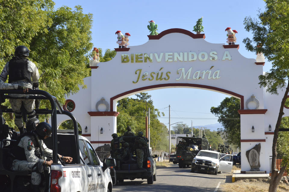 FILE - National Guardsmen drive through the main entrance of Jesus Maria, Mexico, Jan. 7, 2023, the town where Ovidio Guzman, the son of imprisoned drug lord Joaquin "El Chapo" Guzman, was detained. The government's operation unleashed firefights that ended with the death of military personnel and suspected members of the Sinaloa drug cartel, according to authorities. (AP Photo/Martin Urista, File)