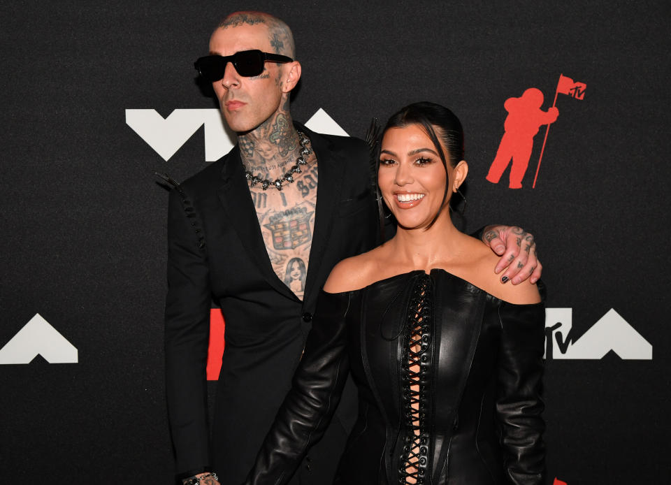 Kourtney Kardashian and fiancé Travis Barker are being criticized online for their extreme public display of affection at a friend's wedding. (Getty Images)