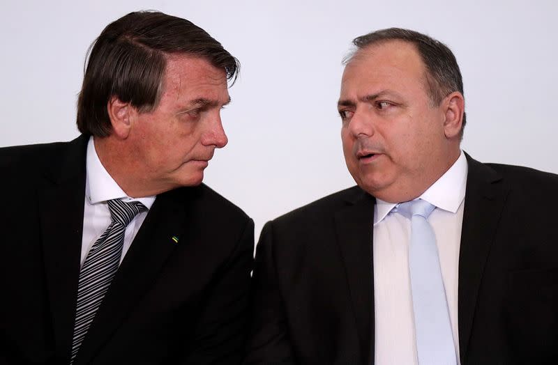 Brazil's President Jair Bolsonaro and Brazil's Health Minister Eduardo Pazuello attend the launch ceremony of a training program for health workers at the Planalto Palace, in Brasilia