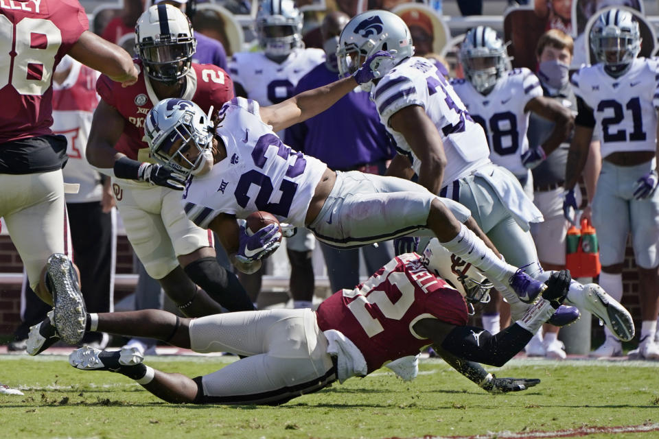 Kansas State wide receiver Joshua Youngblood (23) is upended by Oklahoma defensive back Delarrin Turner-Yell (32) in the first half of an NCAA college football game Saturday, Sept. 26, 2020, in Norman, Okla. (AP Photo/Sue Ogrocki).