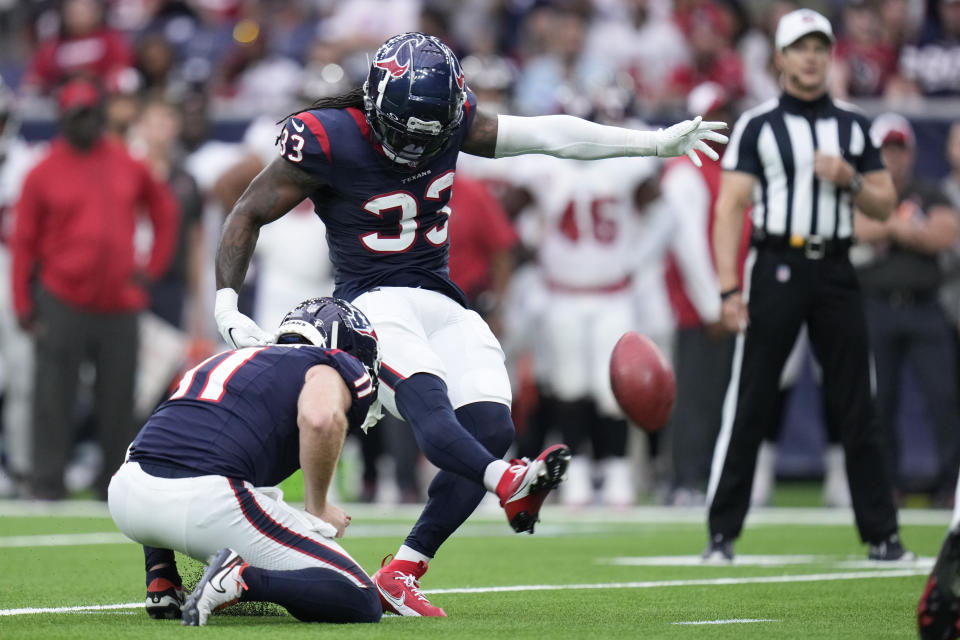 Houston Texans' Dare Ogunbowale (33), with Cameron Johnston (11) holding, kicks a field goal against the Tampa Bay Buccaneers during the second half of an NFL football game, Sunday, Nov. 5, 2023, in Houston. (AP Photo/Eric Christian Smith)
