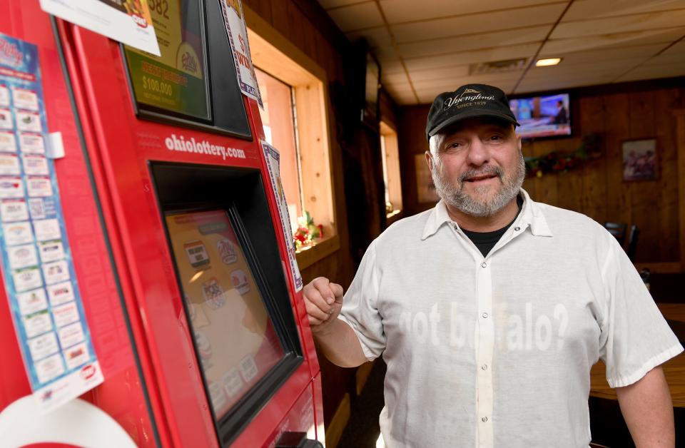 Mike Sylvester, owner of Hide-A-Way Buffalo Grill in Canton, stands by a sports betting kiosk. The restaurant and bar is among roughly a thousand businesses in Ohio licensed to offer sports betting at self-service or clerk-operated terminals starting Jan. 1.