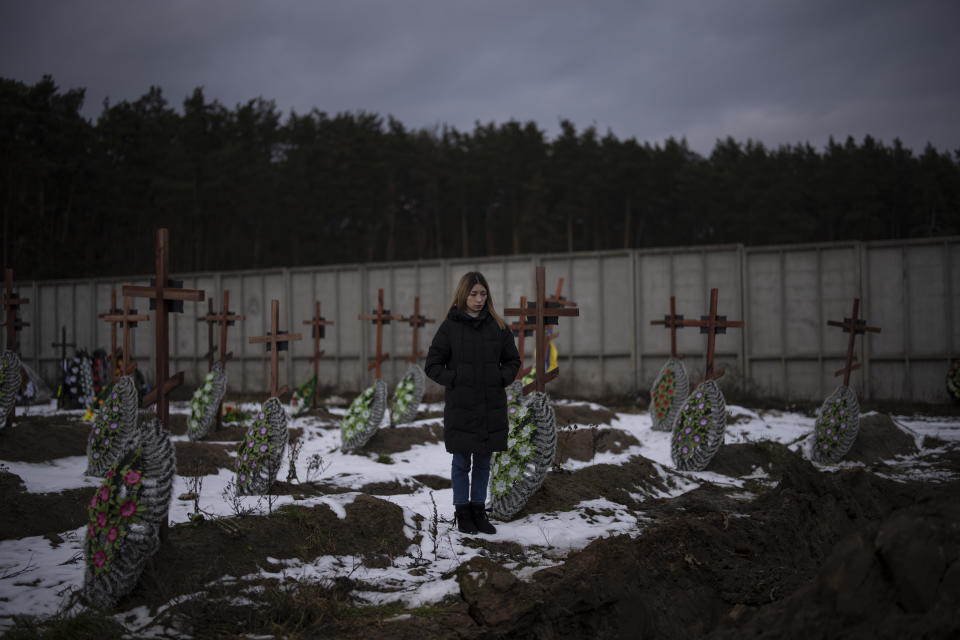 Anastasiia Okhrimenko stands at the cemetery in Bucha, Ukraine, Thursday, Feb. 2, 2023. As the conflict that killed her loved one still rages on, Anastasiia wrestles with a question that all of war-torn Ukraine must grapple with: After loss, what comes next? (AP Photo/Daniel Cole)