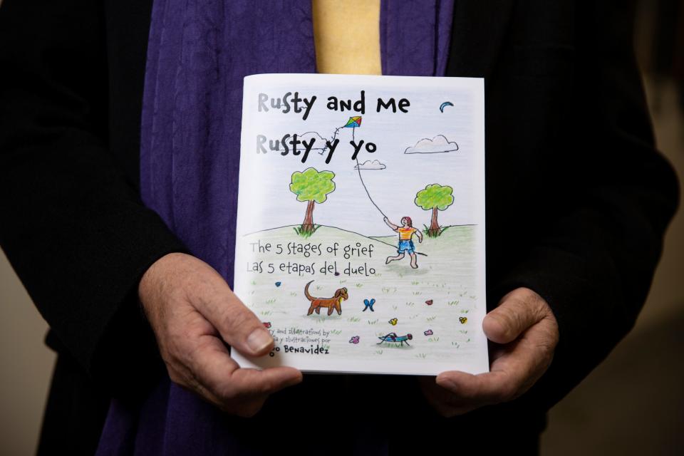 Artist Dago Benavidez poses for a portrait with his children's book about grief at the Salem Public Library in Salem, Ore. on Thursday, Jan. 12, 2023.