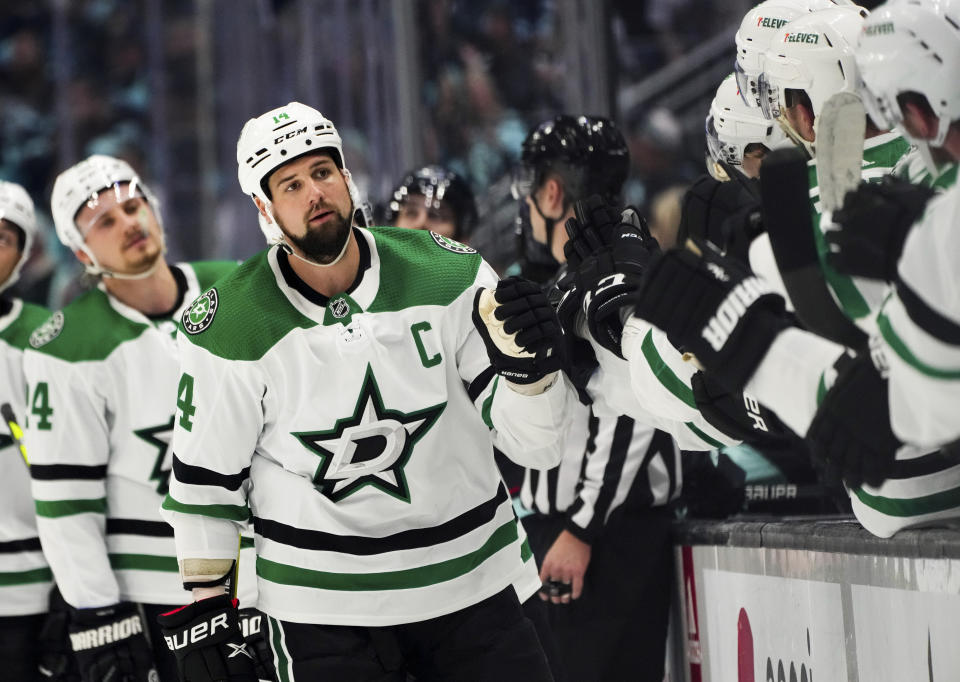 Dallas Stars left wing Jamie Benn (14) is congratulated for his goal against the Seattle Kraken during the first period of Game 4 of an NHL hockey Stanley Cup second-round playoff series Tuesday, May 9, 2023, in Seattle. (AP Photo/Lindsey Wasson)