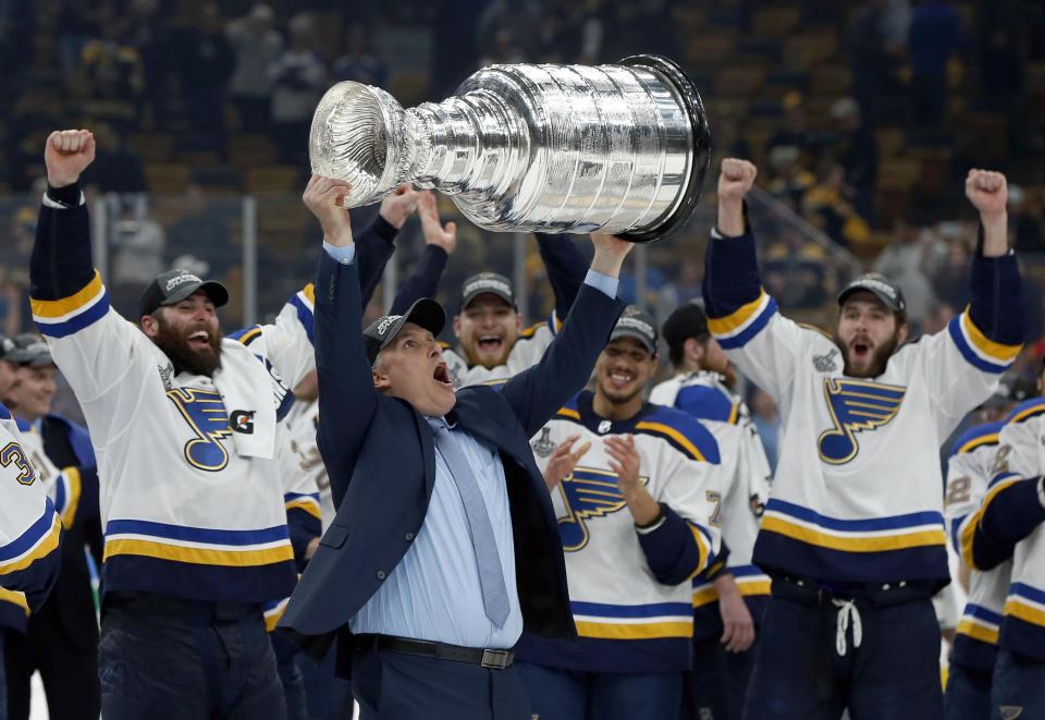 FILE- In this June 12, 2019, file photo, St. Louis Blues head coach Craig Berube carries the Stanley Cup after the Blues defeated the Boston Bruins in Game 7 of the NHL Stanley Cup Final in Boston. (AP Photo/Michael Dwyer, File)