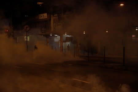 Tear gas thrown by riot police spreads at Causeway Bay, after leader Carrie Lam announced emergency laws that would include banning face masks at protests, in Hong Kong