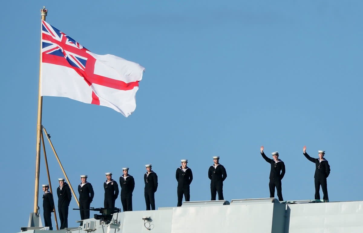 Sailors wave from the stern of the Royal Navy aircraft carrier HMS Prince of Wales as it returns to Portsmouth Naval Base following a three-month deployment to the Eastern Seaboard of the United States (PA)