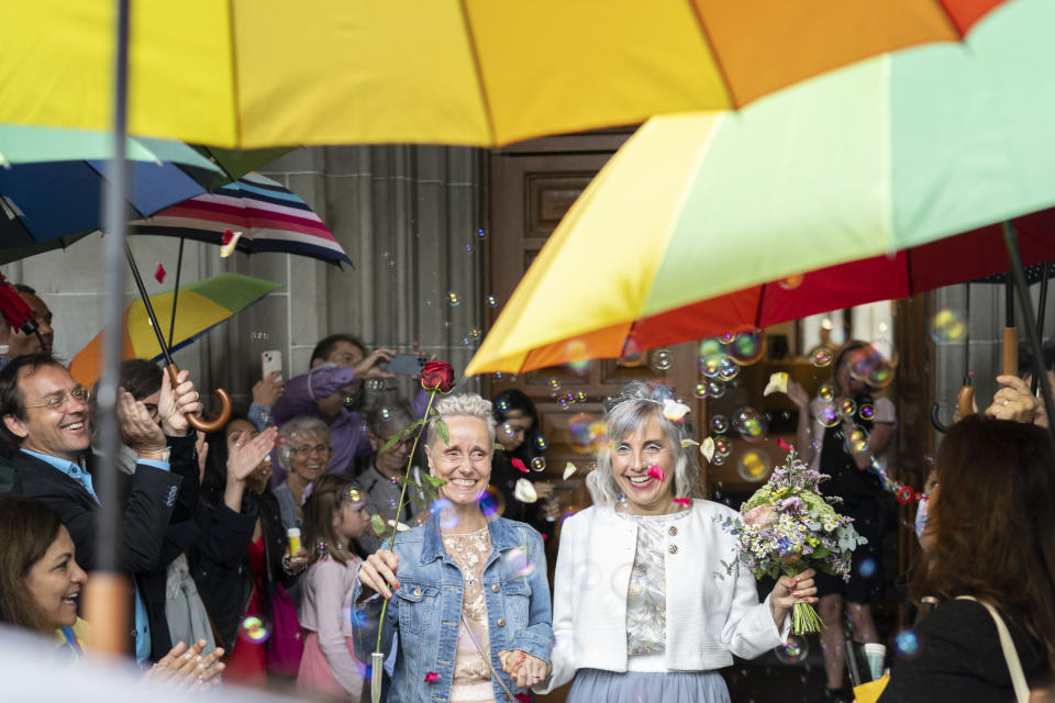 Annett Babinsky, left, and Laura Suarez celebrate their marriage at the registry office 'Amtshaus' in Zurich, Switzerland, Friday, July 1, 2022. After a yes vote in the "Marriage for All" vote last fall, from July 1, same-sex couples marriage for the first time in Switzerland. (Ennio Leanza/Keystone via AP)