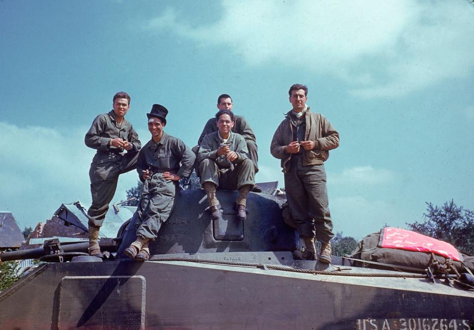 An American tank crew takes a breather on the way through the town of Avranches, Normandy, summer 1944.