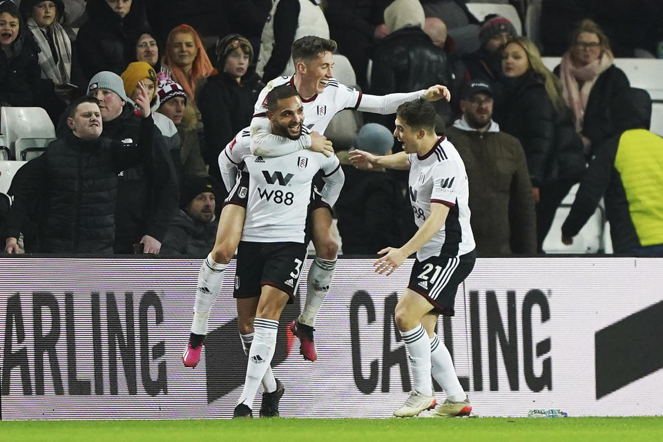 Fulham's Layvin Kurzawa, left, celebrates scoring their side's third goal of the game during the English FA Cup fourth round replay soccer match against Sunderland at the Stadium of Light, Sunderland, England, Wednesday, Feb. 8, 2023. (Owen Humphreys/PA via AP)