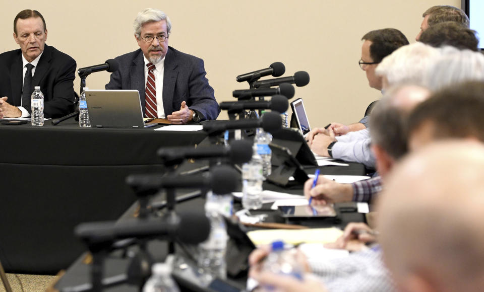 McMinn County director of schools Lee Parkison, left, listens as school board attorney Scott Bennett, second left, advises the board on their role of making policy, Thursday, Feb. 10, 2022, in Athens, Tenn The McMinn County School Board heard from concerned citizens about the removal of the Pulitzer Prize-winning graphic novel about the Holocaust "Maus," from the district's curriculum at the meeting. (Robin Rudd/Chattanooga Times Free Press via AP)