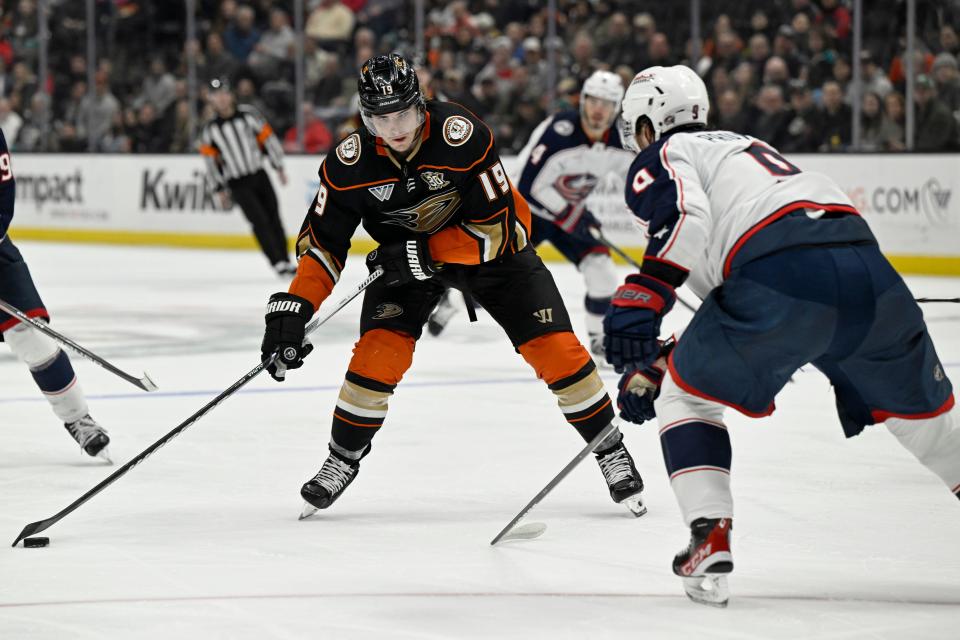 Anaheim Ducks right wing Troy Terry (19) shoots to score against Columbus Blue Jackets defenseman Ivan Provorov, right, during the second period of an NHL hockey game in Anaheim, Calif., Wednesday, Feb. 21, 2024. (AP Photo/Alex Gallardo)