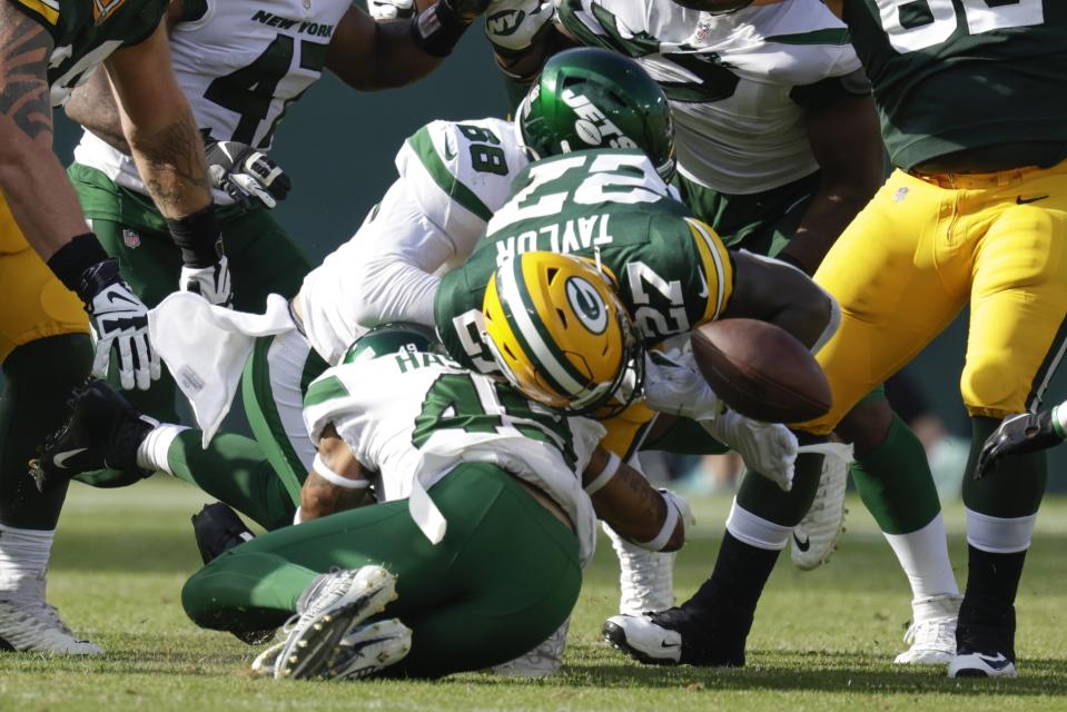 Green Bay Packers' Patrick Taylor fumbles as he is hit by New York Jets' Hamsah Nasirildeen during the second half of a preseason NFL football game Saturday, Aug. 21, 2021, in Green Bay, Wis. (AP Photo/Matt Ludtke)