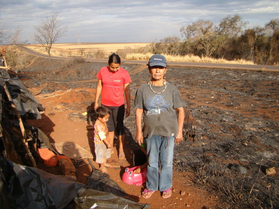 In August 2013, a fire had raged through the Apy Ka'y camp, forcing Damiana and her community to flee as her shelter smoldered and possessions were lost to the blaze. The fire was reported to have started on the São Fernando sugarcane plantation and mill that occupy her ancestral land. It was not the first time her camp had been engulfed by flames; in September 2009, gunmen set the Apy Ka'y shelters alight and attacked members of Damiana’s community. The Guarani now say that the characteristic reddish color of the earth is tinted by the spilled blood of their people. (Photo by Spensy Pimentel/Survival International)