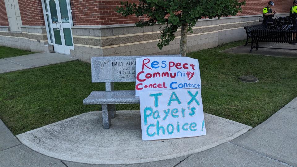 Signs were placed in front of Central Middle School in Quincy before a meeting about the temporary shelter for homeless families housed on the campus of Eastern Nazarene College.