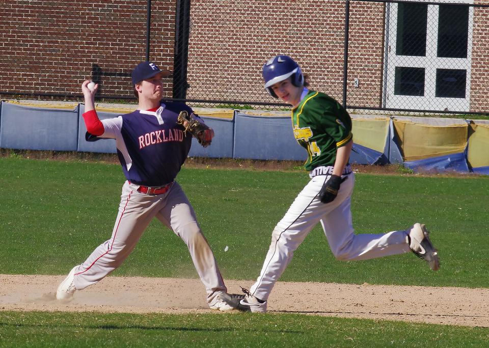 South Shore Vocational runner Jock Lewis (R) runs toward second base but he's already out as Rockland shortstop Ian White (L)  throws to firstst for the inning-ending double play on Wednesday, April 20, 2022.