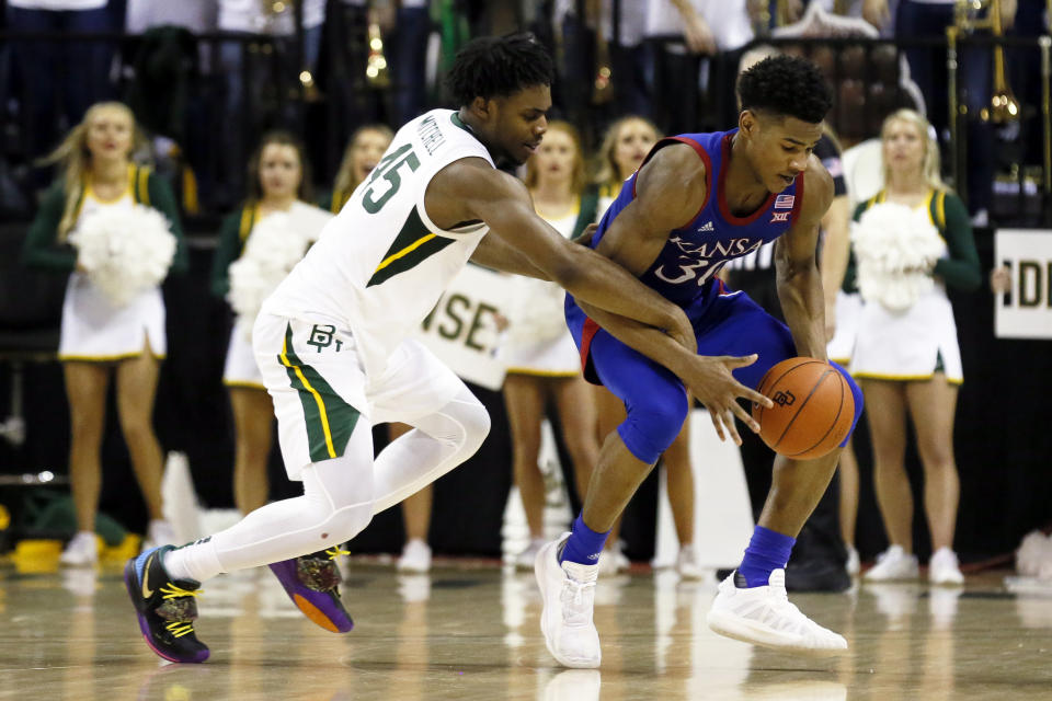 Baylor guard Davion Mitchell, left, defends Kansas guard Ochai Agbaji, right, during the second half of an NCAA college basketball game on Saturday, Feb. 22, 2020, in Waco, Texas. (AP Photo/Ray Carlin)