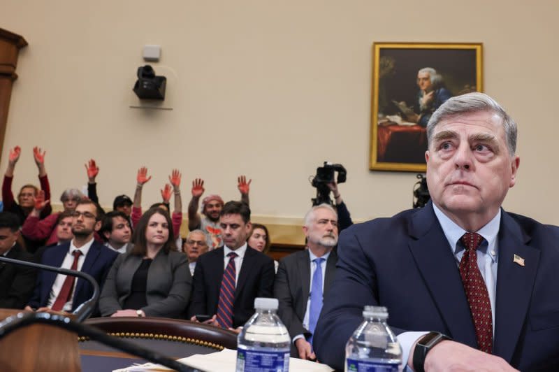 Protesters stand with red paint on their hands as former Joint Chief Chairman Gen. Mark Milley prepares to give testimoy on Tuesday. Photo by Jemal Countess/UPI