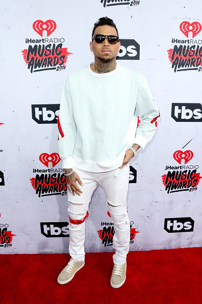 Chris Brown rocking white jeans with a crew-neck sweatshirt. 