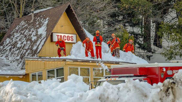 PHOTO: Inmate firefighters clear snow off the roof of a restaurant, March 7. 2023, in Lake Arrowhead, Calif. (Kyle Grillot/Bloomberg via Getty Images)