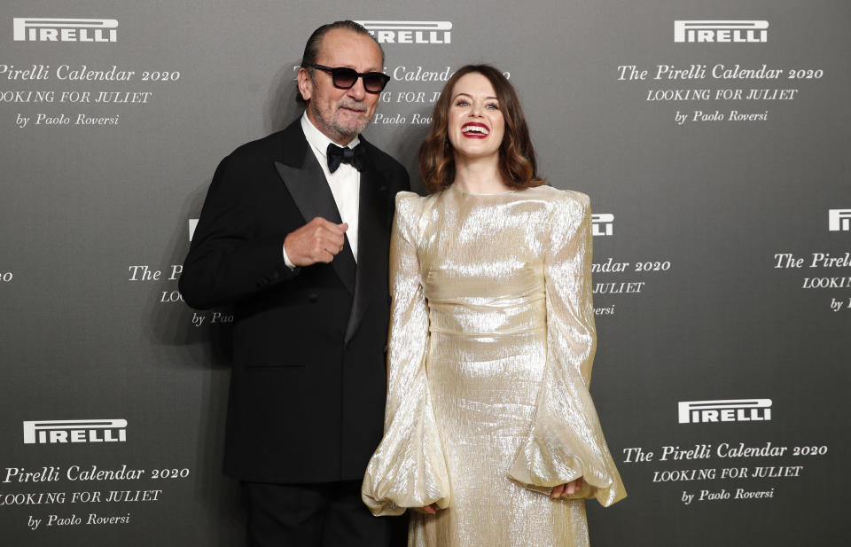 British actress Claire Foy, right, poses with Italian photographer Paolo Roversi, at the 2020 Pirelli Calendar event in Verona, Italy, Tuesday, Dec. 3, 2019. (AP Photo/Antonio Calanni)