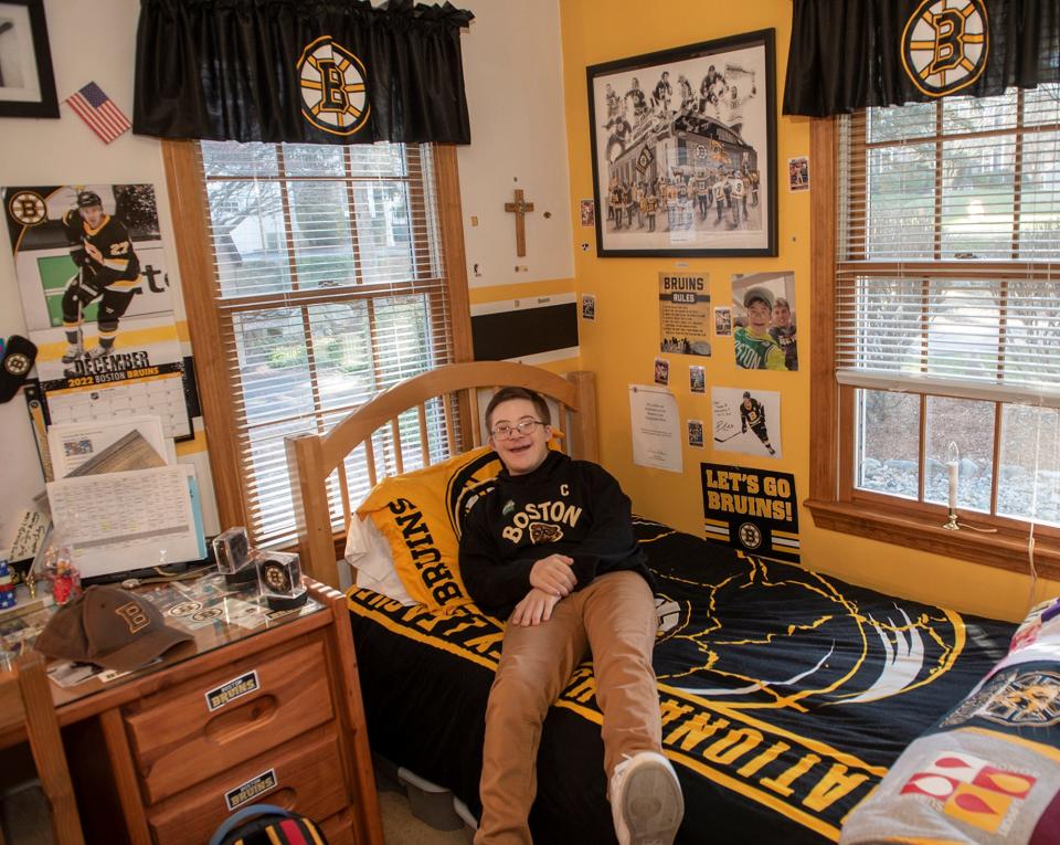 Liam Fitzgerald, 15, of Northborough, pictured in his bedroom Dec. 29, 2022. He will attend and also fist bump Bruins players at the Winter Classic at Fenway Park, Jan. 2, 2023.