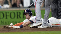 Houston Astros' Myles Straw scores on a wild pitch by Texas Rangers relief pitcher Brett Martin during the 11th inning of a baseball game Thursday, May 13, 2021, in Houston. The Astros won 4-3 in 11 innings. (AP Photo/David J. Phillip)