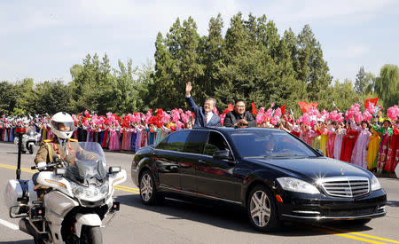 South Korean President Moon Jae-in and North Korean leader Kim Jong Un react during a car parade in Pyongyang, North Korea, September 18, 2018. Pyeongyang Press Corps/Pool via REUTERS