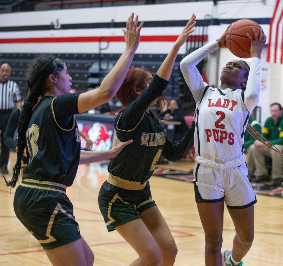 McKinley's Paris Stokes (right) shoots during a Division I sectional final game against GlenOak last week.