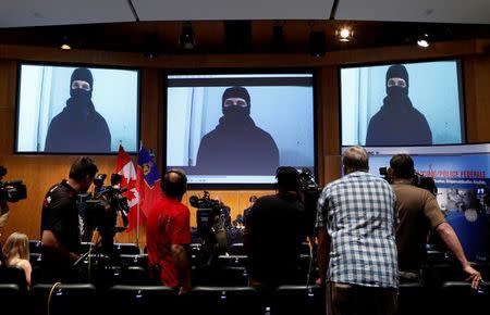 A video of Aaron Driver, a Canadian man killed by police on Wednesday who had indicated he planned to carry out an imminent rush-hour attack on a major Canadian city, is projected on a screen during a news conference at the Royal Canadian Mounted Police (RCMP) headquarters in Ottawa, Ontario, Canada, August 11, 2016. REUTERS/Chris Wattie