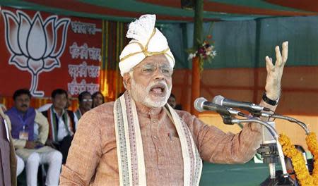 Gujarat's chief minister Narendra Modi, the prime ministerial candidate for Bharatiya Janata Party (BJP), wearing a turban addresses his supporters during a rally ahead of the 2014 general elections in Assam February 22, 2014. REUTERS/Stringer