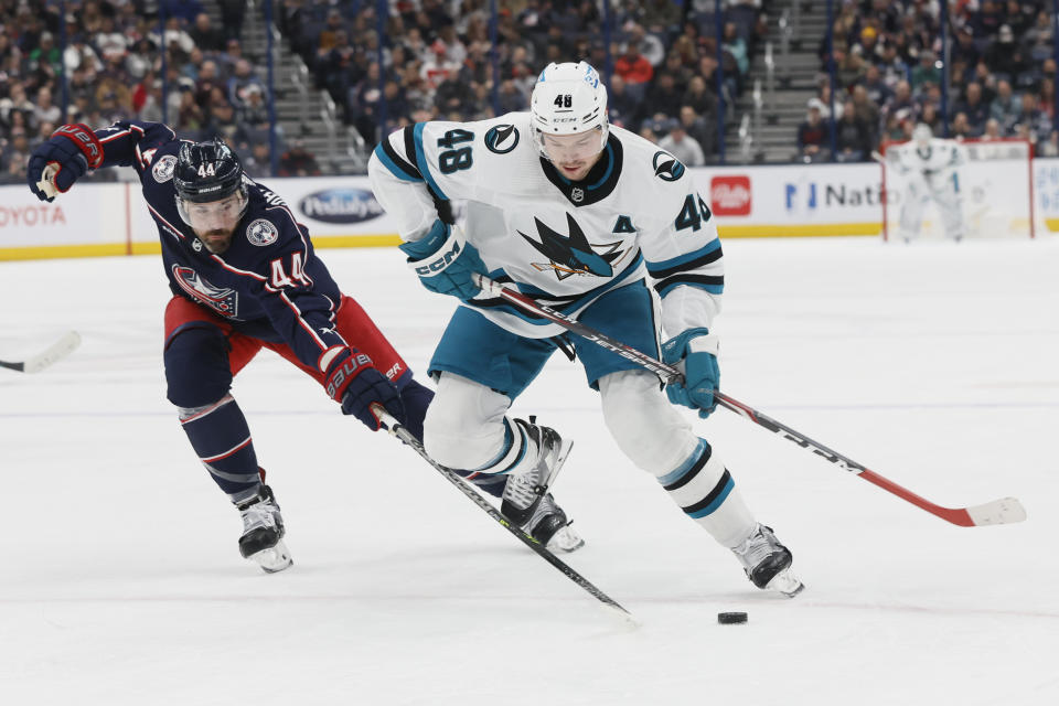San Jose Sharks' Tomas Hertl, right, keeps the puck away from Columbus Blue Jackets' Erik Gudbranson during the first period of an NHL hockey game on Saturday, Jan. 21, 2023, in Columbus, Ohio. (AP Photo/Jay LaPrete)