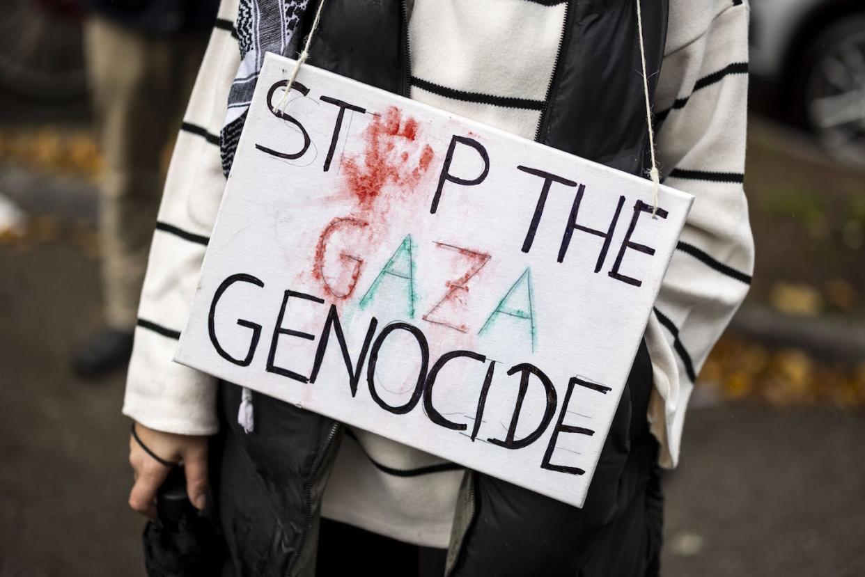 People holding signs calling for an end to genocide in the Gaza Strip have been a common occurrence at pro-Palestinian protests. <a href="https://www.gettyimages.com/detail/news-photo/november-2023-north-rhine-westphalia-duesseldorf-a-woman-news-photo/1763959058?adppopup=true" rel="nofollow noopener" target="_blank" data-ylk="slk:Christoph Reichwein/picture alliance via Getty Images;elm:context_link;itc:0;sec:content-canvas" class="link ">Christoph Reichwein/picture alliance via Getty Images</a>