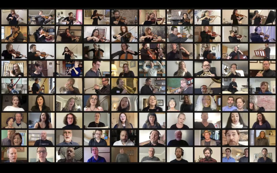 In a photo provided by the Metropolitan Opera, members of the Metropolitan Opera Orchestra and chorus performing from homes for the company’s At-Home gala, which was transmitted Saturday, April 25, 2020. Music director Yannick Nézet-Séguini in Mointreal is in the fourth row from top, sixth from left. (Metropolitan Opera via AP)