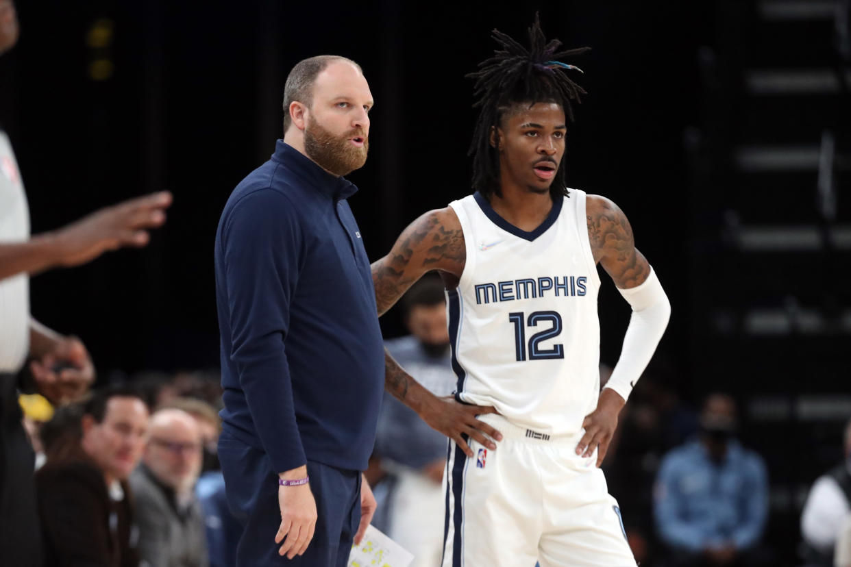 Memphis Grizzles head coach Taylor Jenkins talks with guard Ja Morant during a game. 