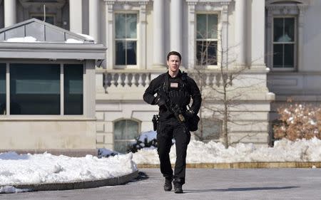 A Secret Service agent tells the press to return to the press room prior to U.S. President Barack Obama and First Lady Michelle Obama's departure from the White House in Washington, for a day trip to Selma, Alabama, March 7, 2015. REUTERS/Mike Theiler