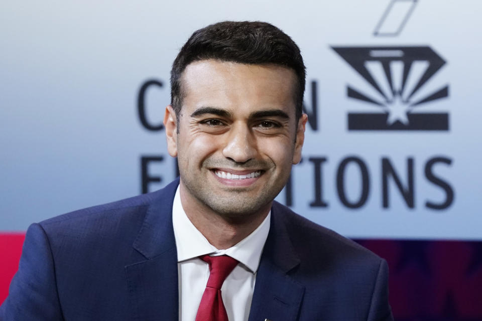 Republican Abraham Hamadeh, candidate Arizona Attorney General, smiles prior to a televised debate against Democrat Kris Mayes, Wednesday, Sept. 28, 2022. (AP Photo/Ross D. Franklin)