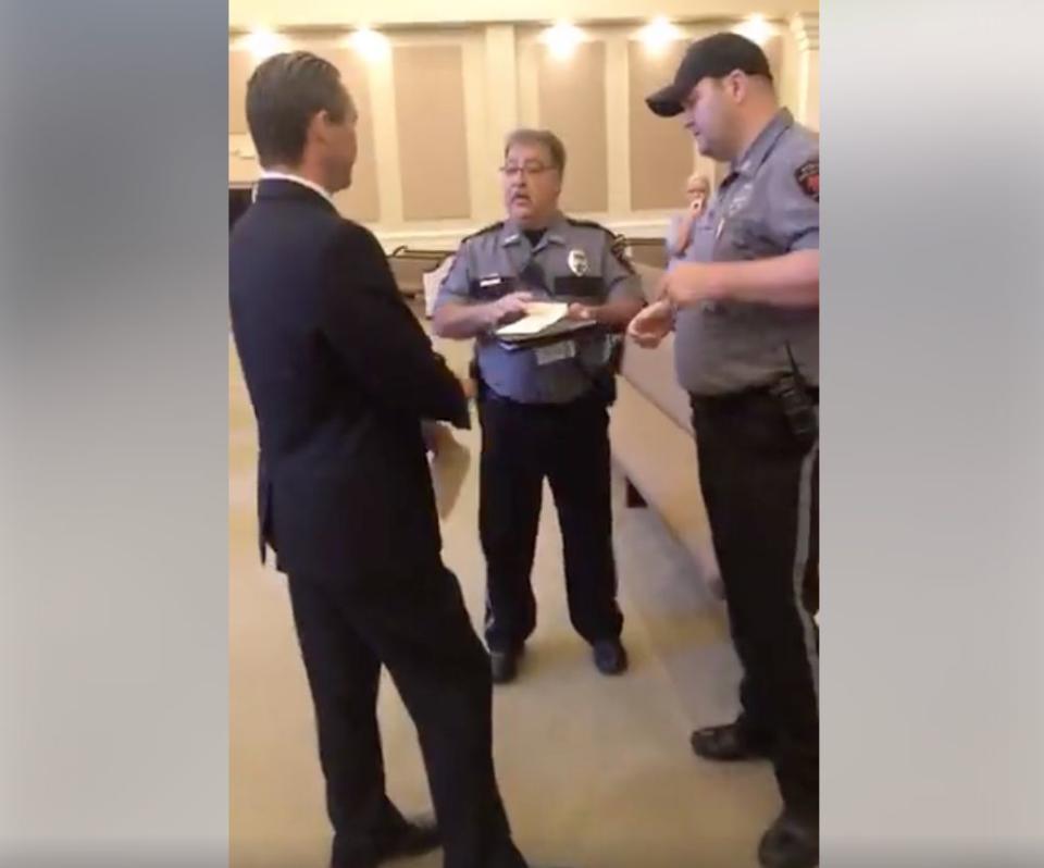 Two Central Police Department officers issue a misdemeanor summons to Life Tabernacle Church pastor Tony Spell. (Photo: Facebook Live / Timothy C. Spell)