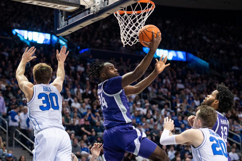 Kansas State forward Arthur Kaluma (24) goes up for a shot at the basket while guarded by BYU's Dallin Hall (30) on Saturday night at Marriott Center in Provo, Utah.