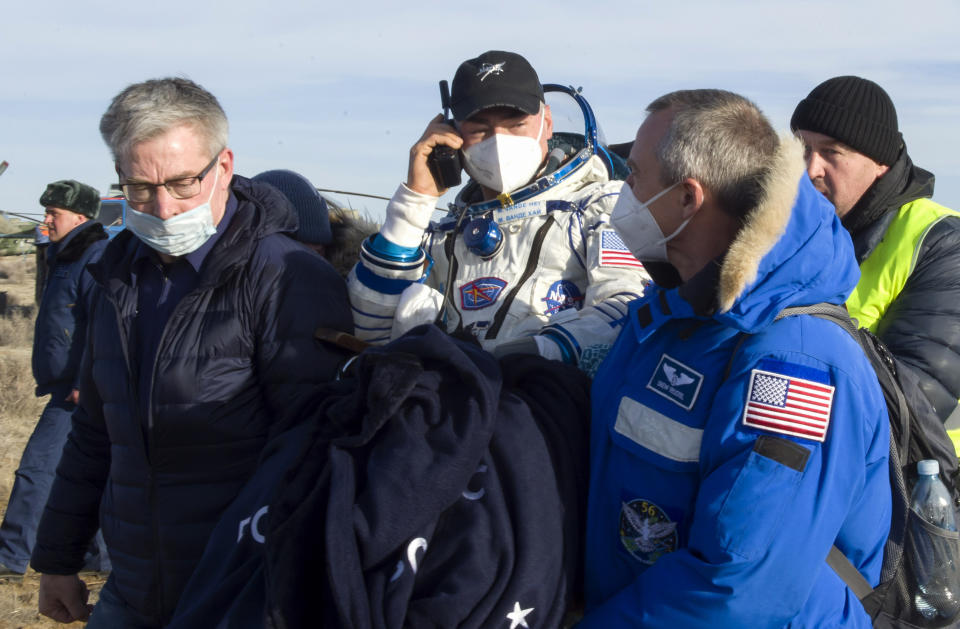 In this photo released by Roscosmos Space Agency, rescue team members carry NASA astronaut Mark Vande Hei shortly after the landing of the Russian Soyuz MS-19 space capsule southeast of the Kazakh town of Zhezkazgan, Kazakhstan, Wednesday, March 30, 2022. The Soyuz MS-19 capsule landed upright in the steppes of Kazakhstan on Wednesday with NASA astronaut Mark Vande Hei, Russian Roscosmos cosmonauts Anton Shkaplerov and Pyotr Dubrov. (Irina Spektor, Roscosmos Space Agency via AP)